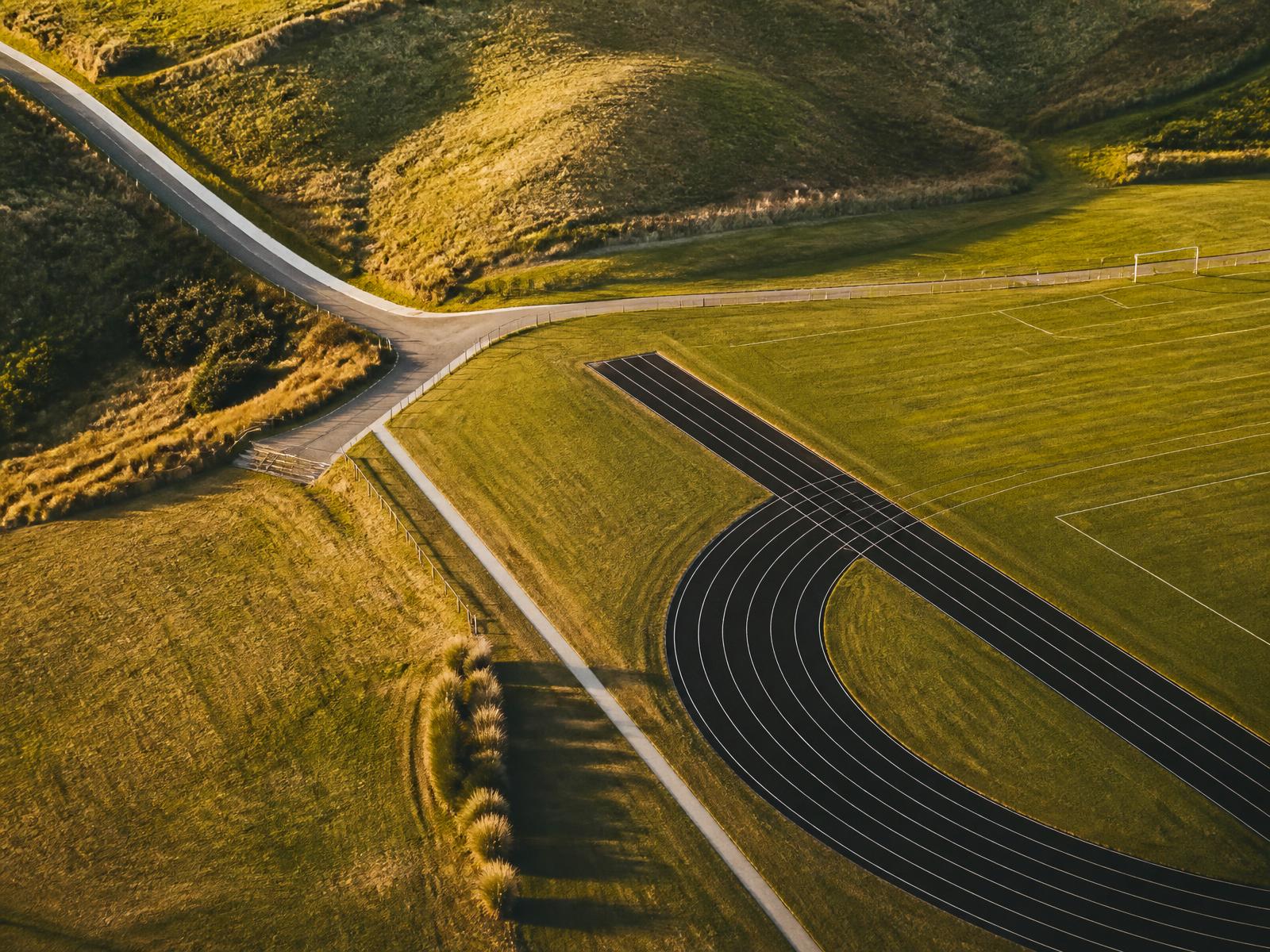 Aerial view of a running track and playing fields in the New Zealand countryside